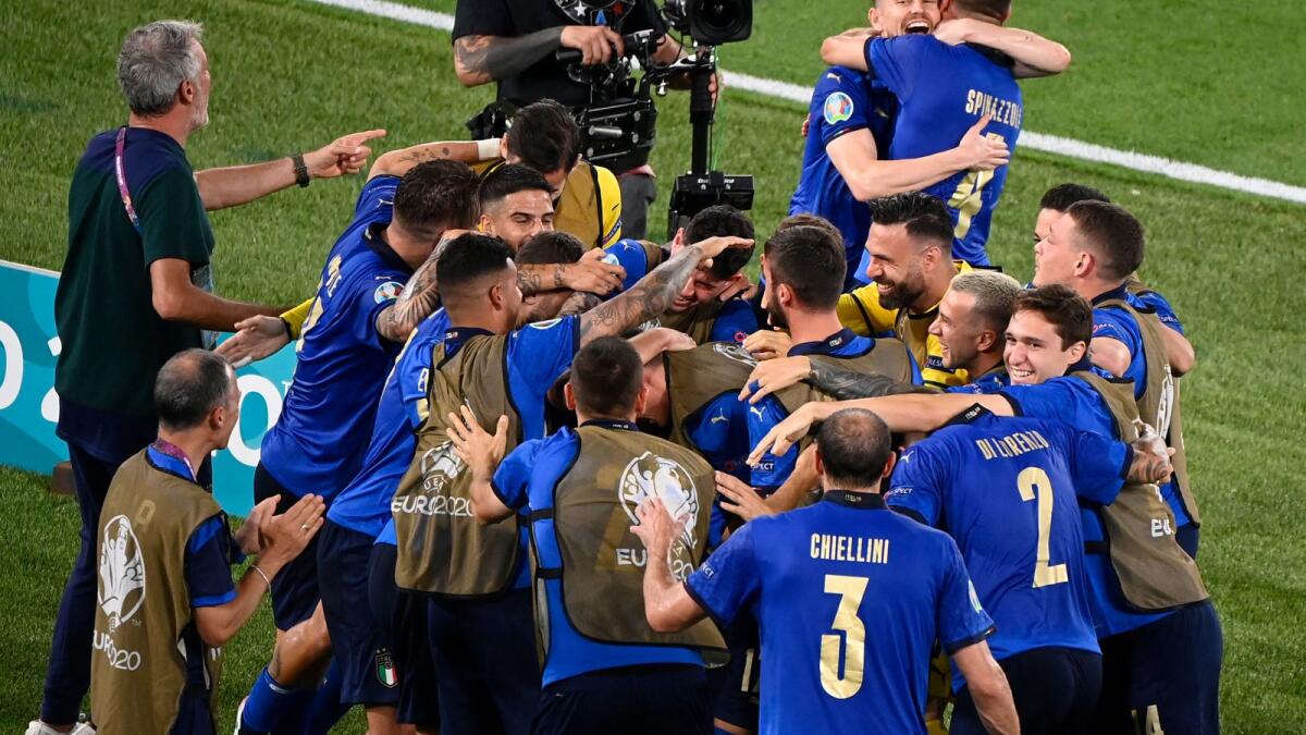 Italy's players celebrate the team's first goal against Switzerland. (AFP)
