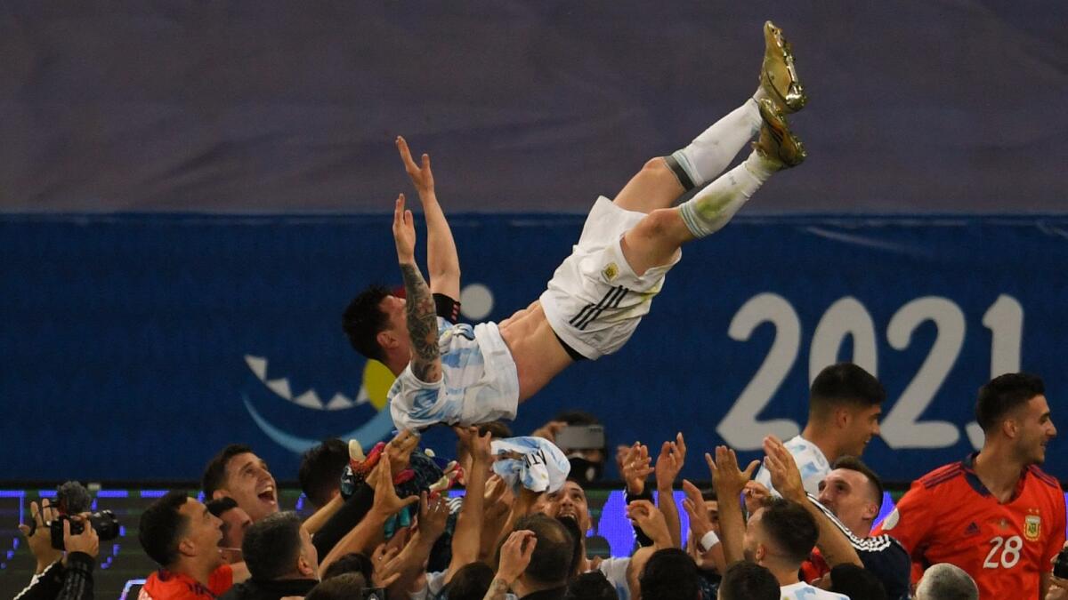 Argentina's Lionel Messi is thrown into the air by teammates after their Copa America victory. (AFP)