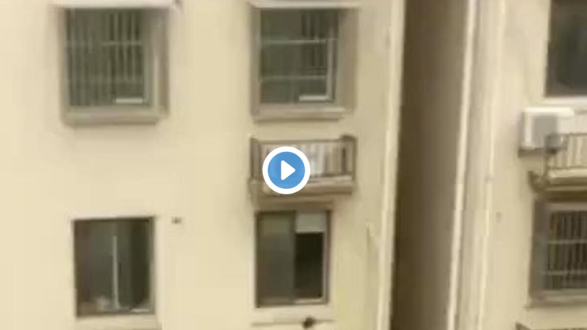 Video: Men climb building to save child trapped on window