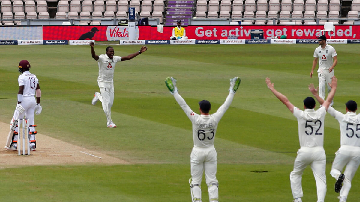 England's Jofra Archer (second left) celebrates after trapping West Indies' Shamarh Brooks (left) leg before wicket on the fifth day of the first Test cricket match at the Ageas Bowl in Southampton, southwest England on Sunday. - AFP