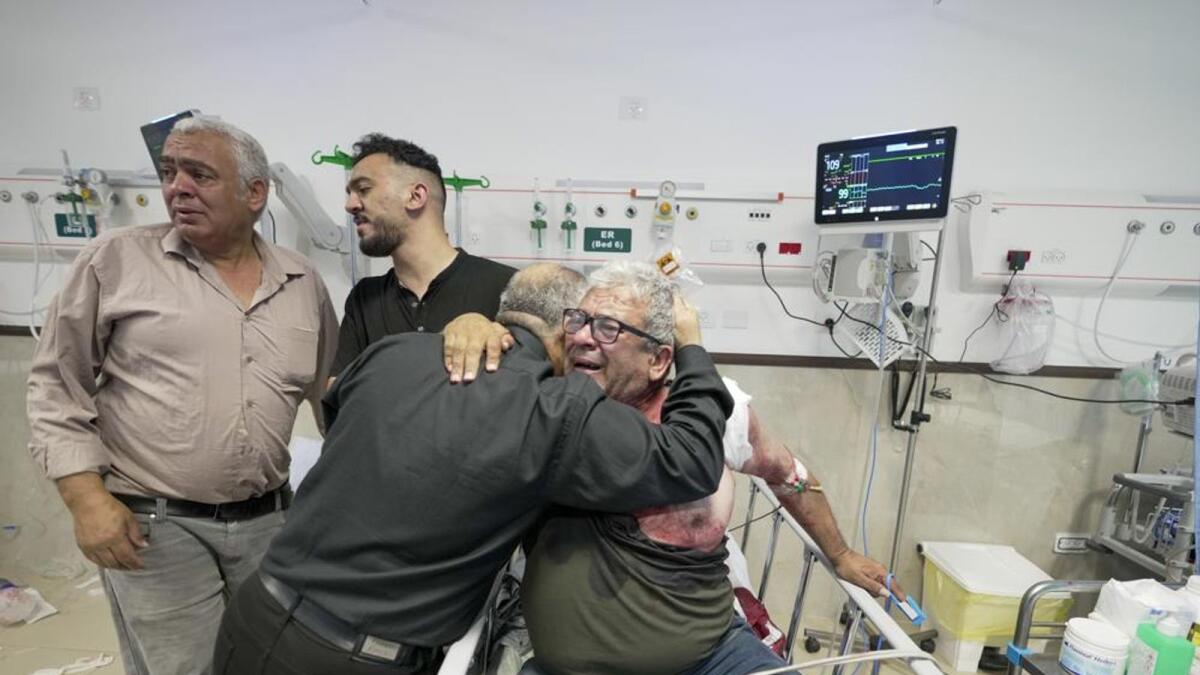 An injured journalist is being hugged by one of the colleagues of killed journalist Shireen Abu Akleh, a journalist for the Al-Jazeera network, in the Hospital West Bank town of Jenin. Photo: AP