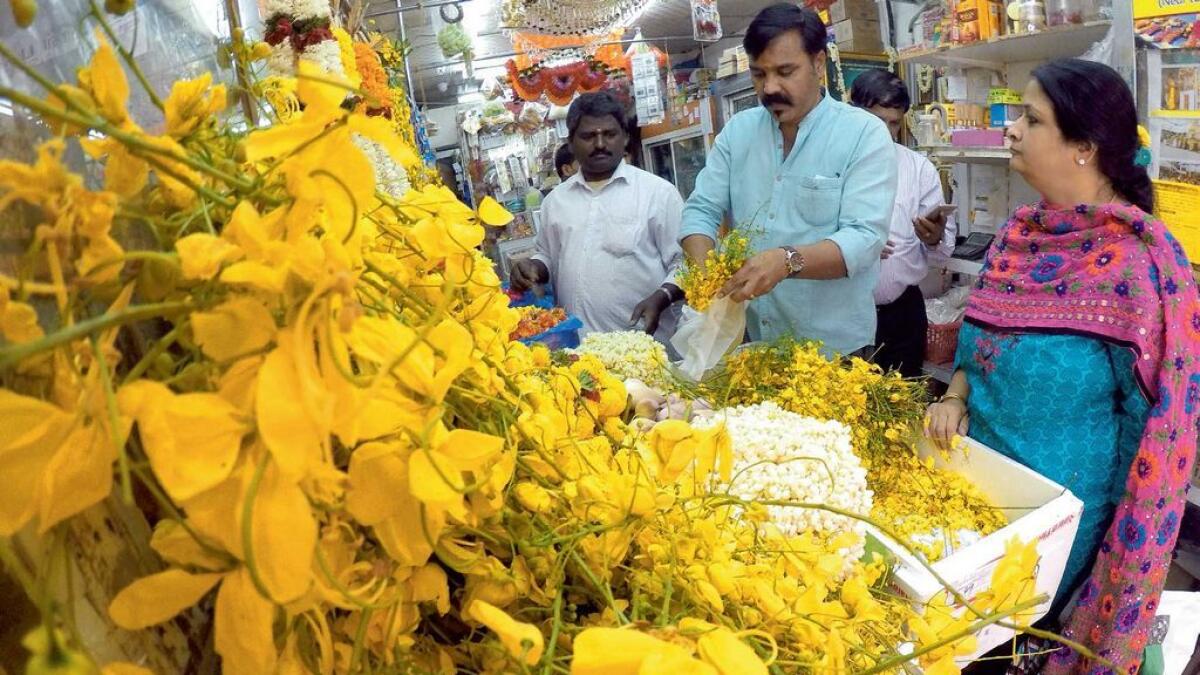 Customers pick out konna (golden rain tree) blooms at a flower shop in Bur Dubai. 
