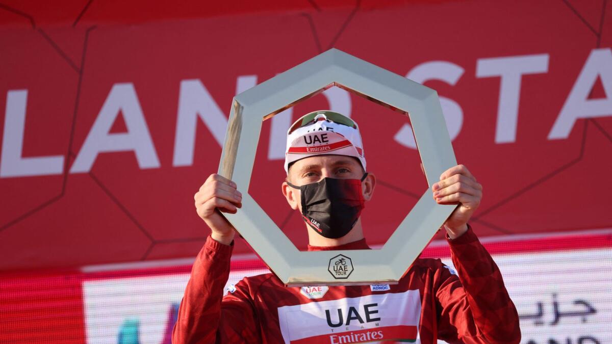 Tadej Pogacar of Team UAE Emirates celebrates on the podium after winning the UAE Cycling Tour. — AFP