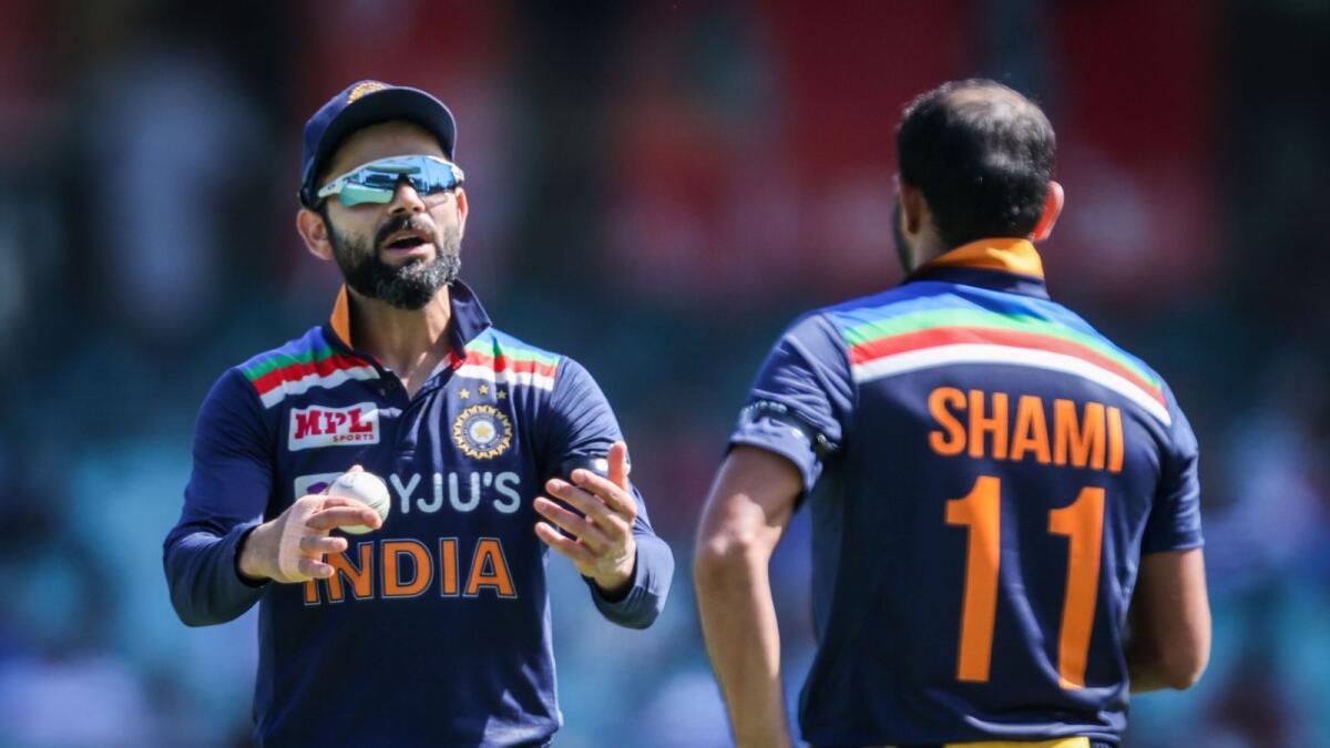 India's captain Virat Kohli (left) talks with teammate Mohammed Shami during the first ODI against Australia. (AFP)