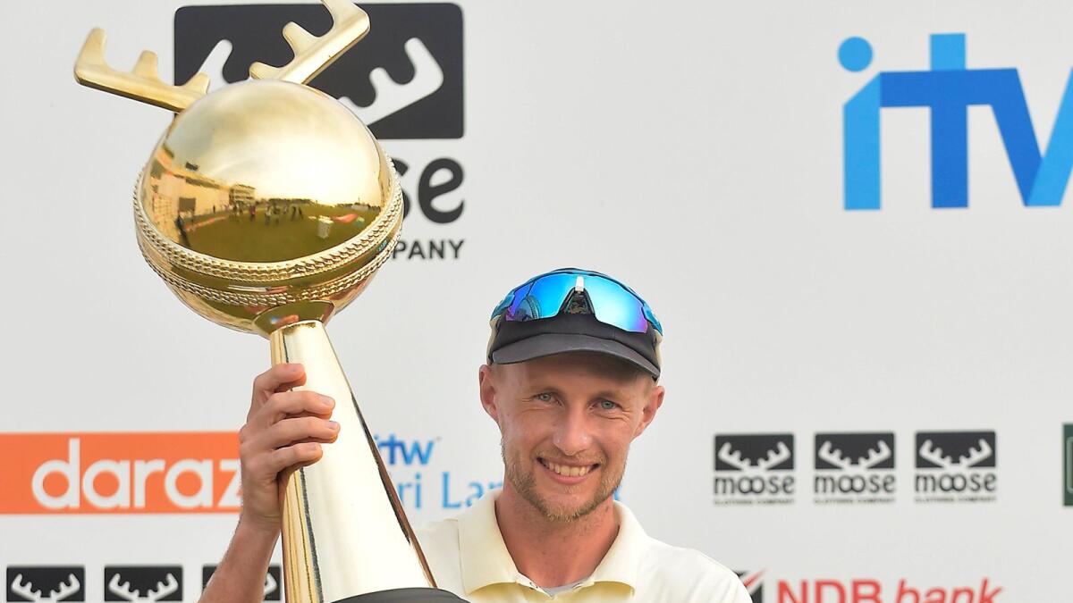 Joe Root celebrates with the trophy. — Twitter