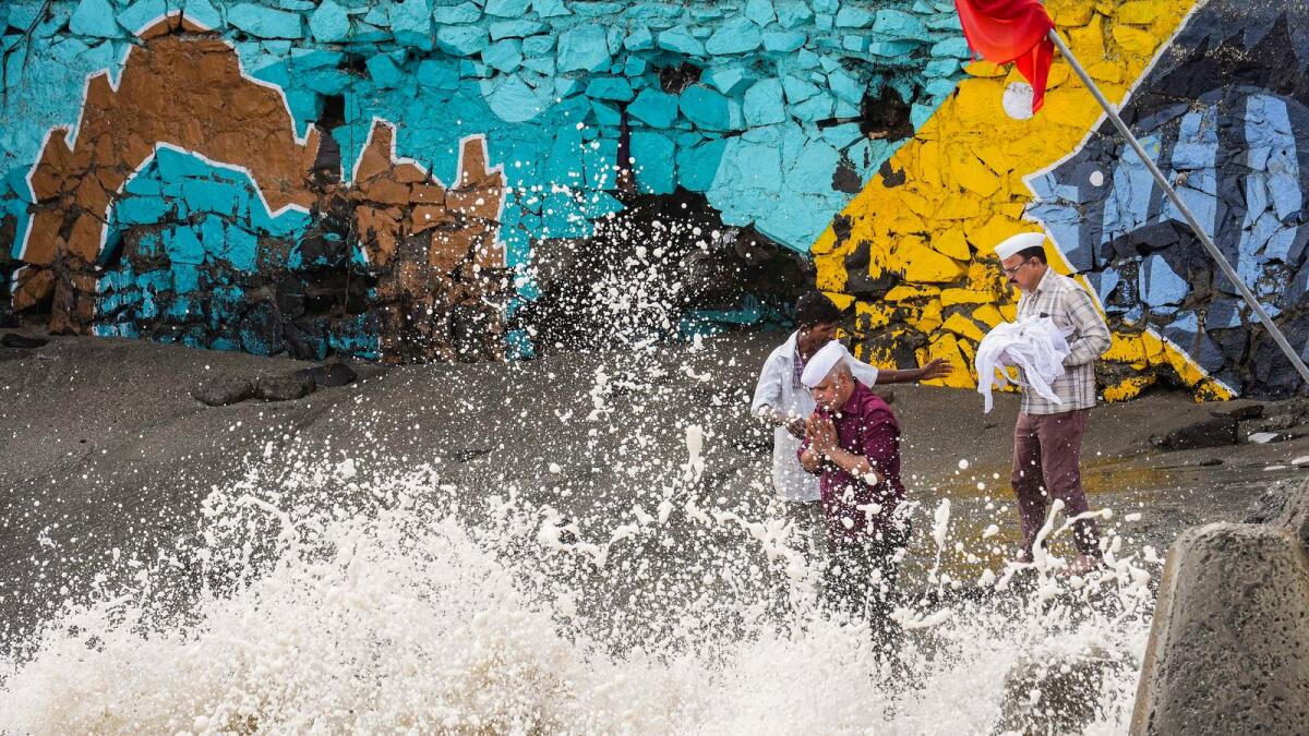 Locals react as high tidal waves lash the shore ahead of the landfall of Cyclone Biparjoy, in Mumbai, on Wednesday.  — PTI