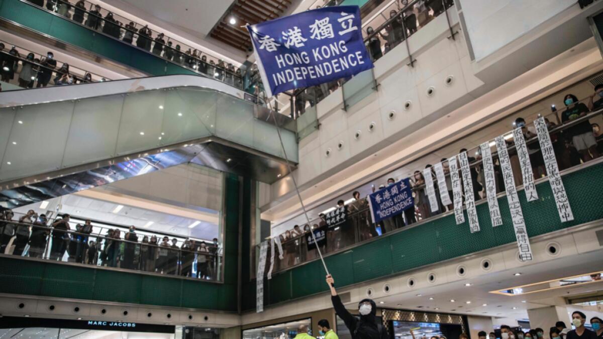 Protesters attend a pro-democracy rally at a shopping mall in Hong Kong. Thousands of Hong Kongers sang a protest anthem and chanted slogans across the city on June 12 as they marked the one-year anniversary of major clashes between police and pro-democracy demonstrators. Photo: AFP