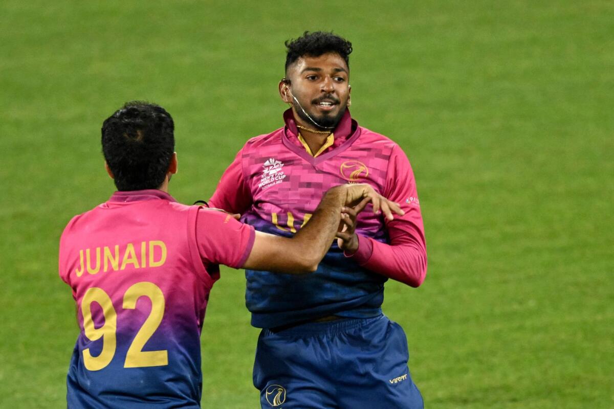 UAE's Karthik Meiyappan celebrates his hat trick with teammate Junaid Siddique during the ICC T20 World Cup match against Sri Lanka at Kardinia Park in Geelong on October 18, 2022. — AFP