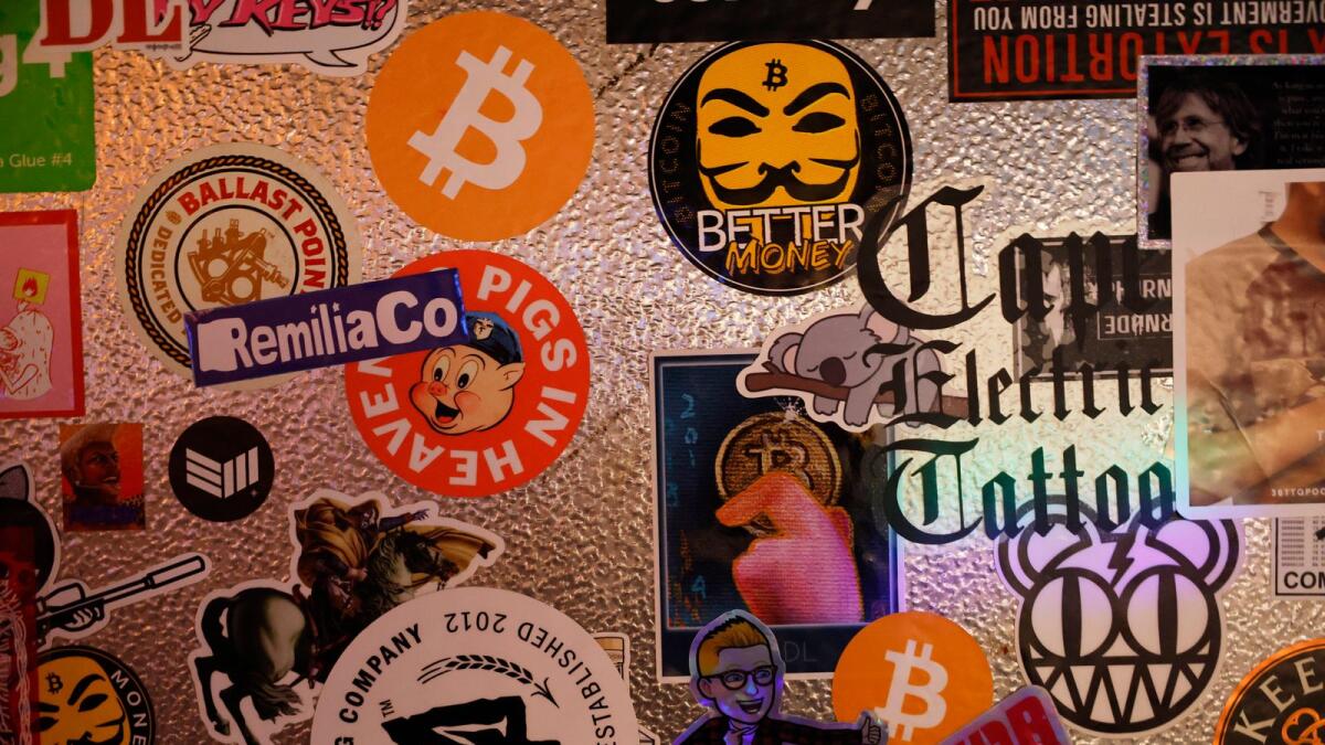 Bitcoin stickers are seen at in New York City. A flush of investor cash has been flowing into the cryptocurrency. — AFP