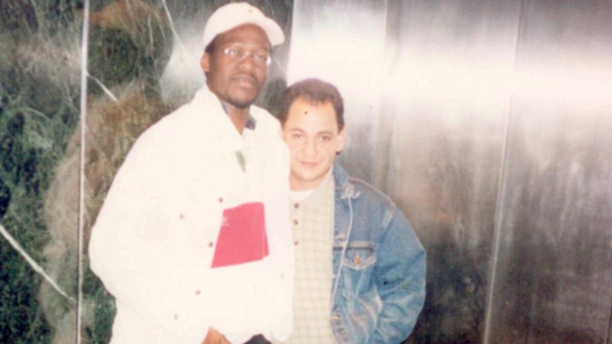 This undated photo provided by Sekou Siby shows Sekou Siby with Isidro Ottenwalder, a coworker of his who died on 9/11. — AP