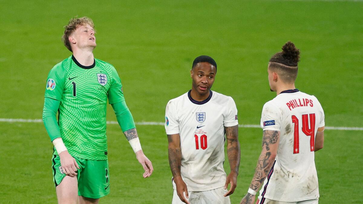 England's goalkeeper Jordan Pickford (left), Raheem Sterling (centre) and Kalvin Phillips react during the final against Italy. — AFP