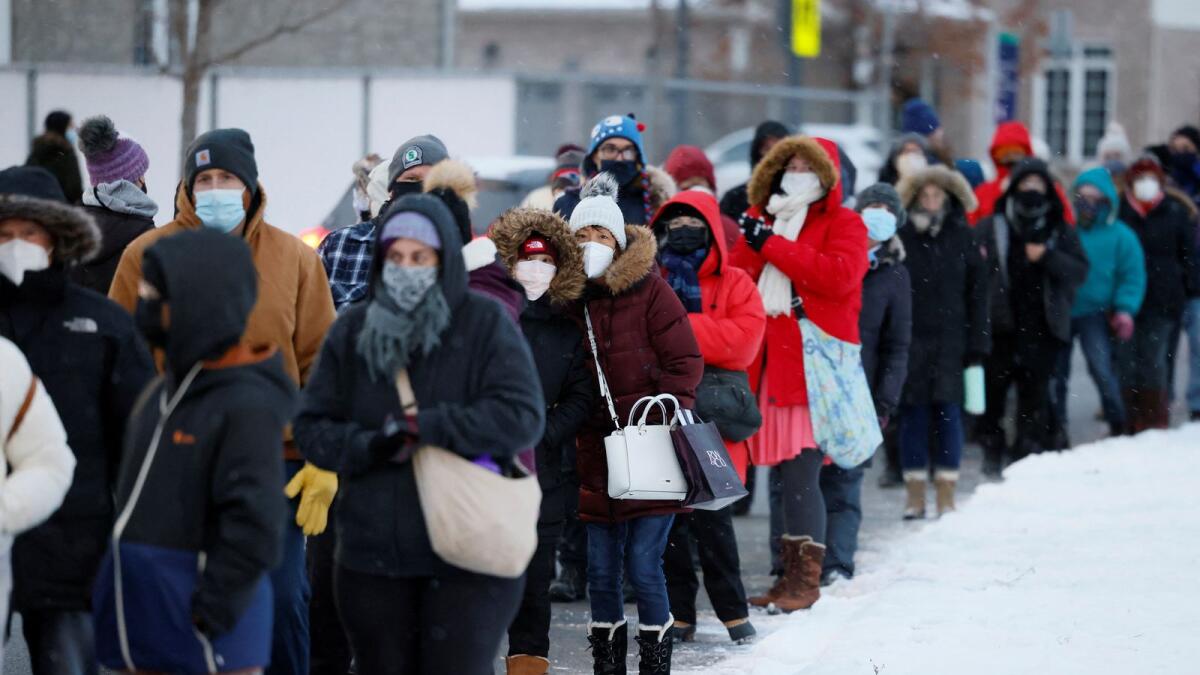 People queue to pick up Covid-19 antigen test kits in Ottawa, Ontario. — Reuters