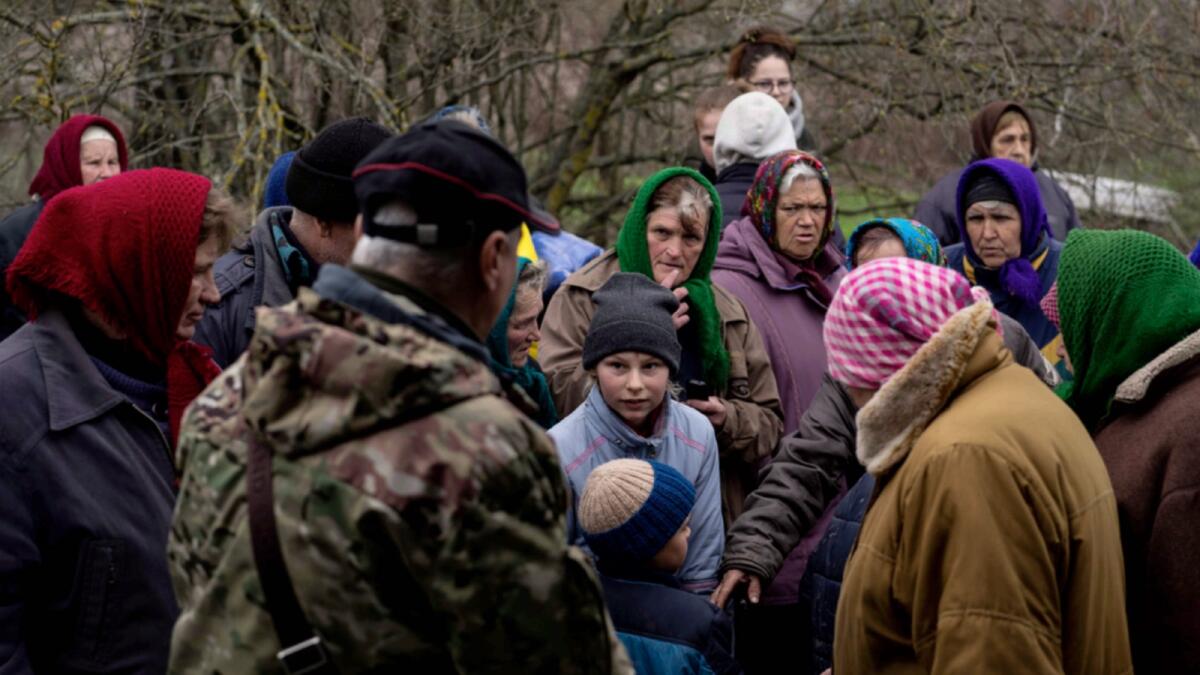 People wait to receive food on the outskirt of Chernihiv, Ukraine. — AP