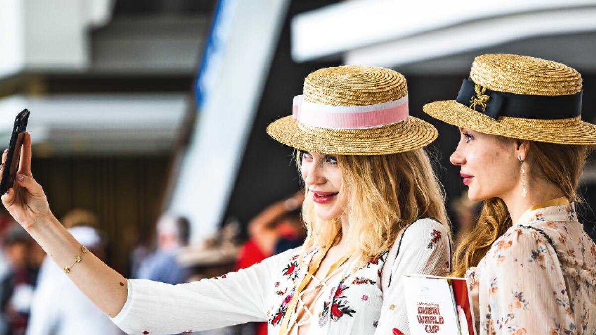 Visitor in fancy dress and hat at the Dubai WorldAttendees take a selfie during the Dubai World Cup in Meydan. — Photo by Neeraj Murali