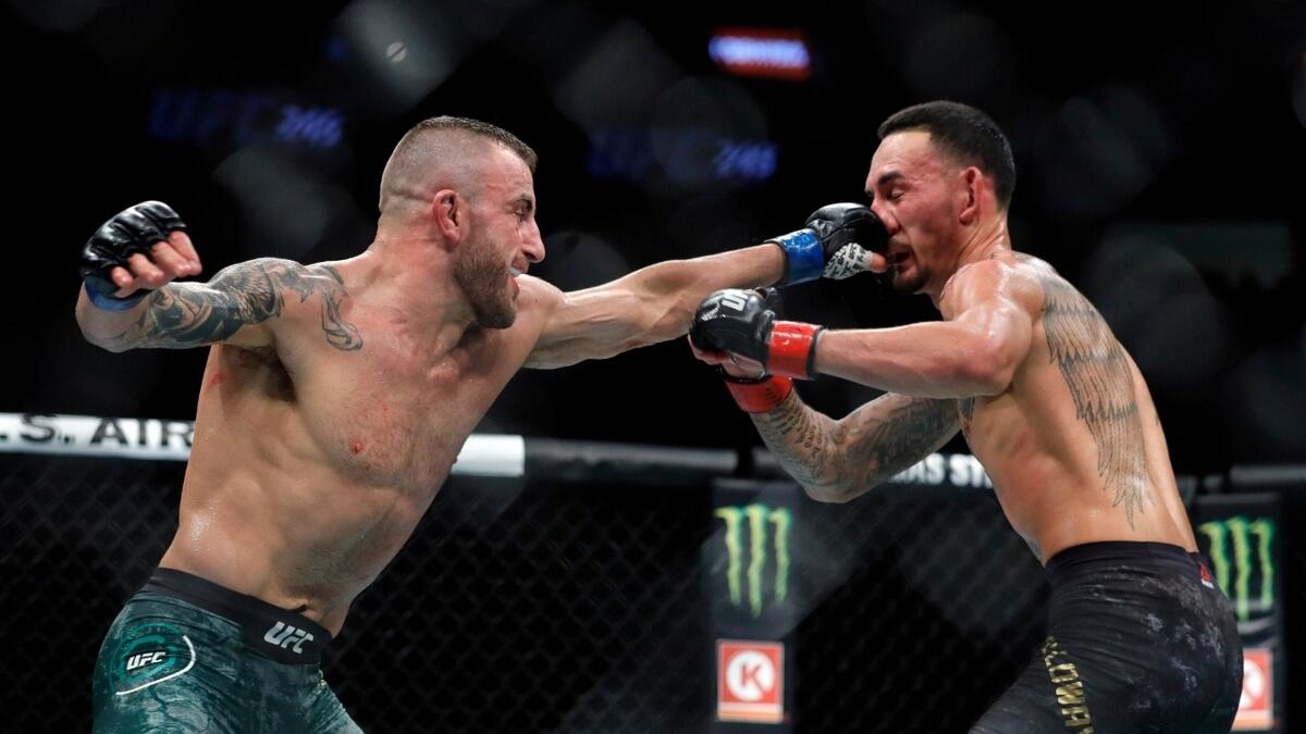 Float like a butterfly, sting like a bee: Alexander Volkanovski (left) punches Max Holloway in their title fight during UFC 245 at the T-Mobile Arena in Las Vegas, last December. Volkanovski took the title by unanimous decision. -- AFP file