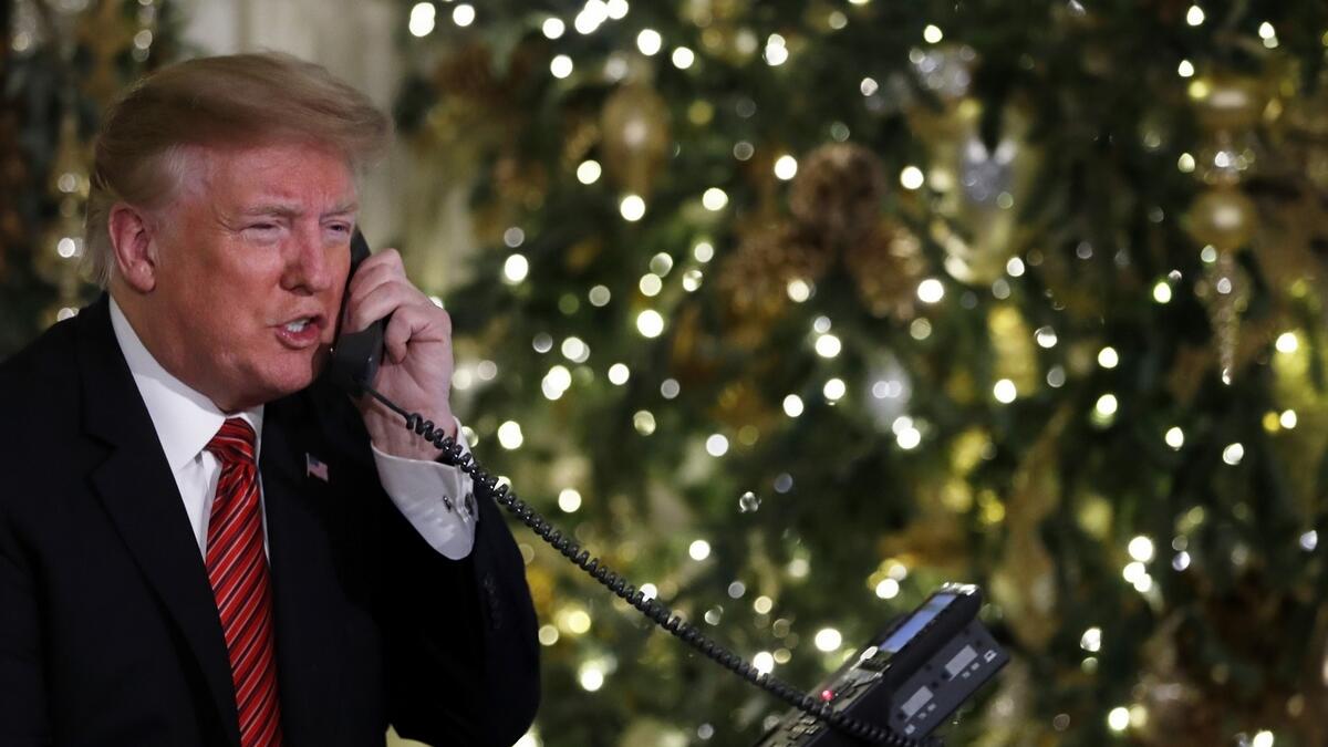 US President Donald Trump speaks on the phone.-AP 