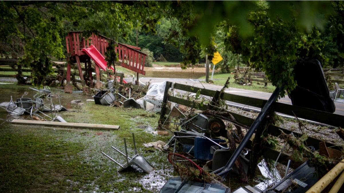 Debris from flooding is strewn along Sam Hollow Road following heavy rainfall in Tennessee on Saturday. — AP