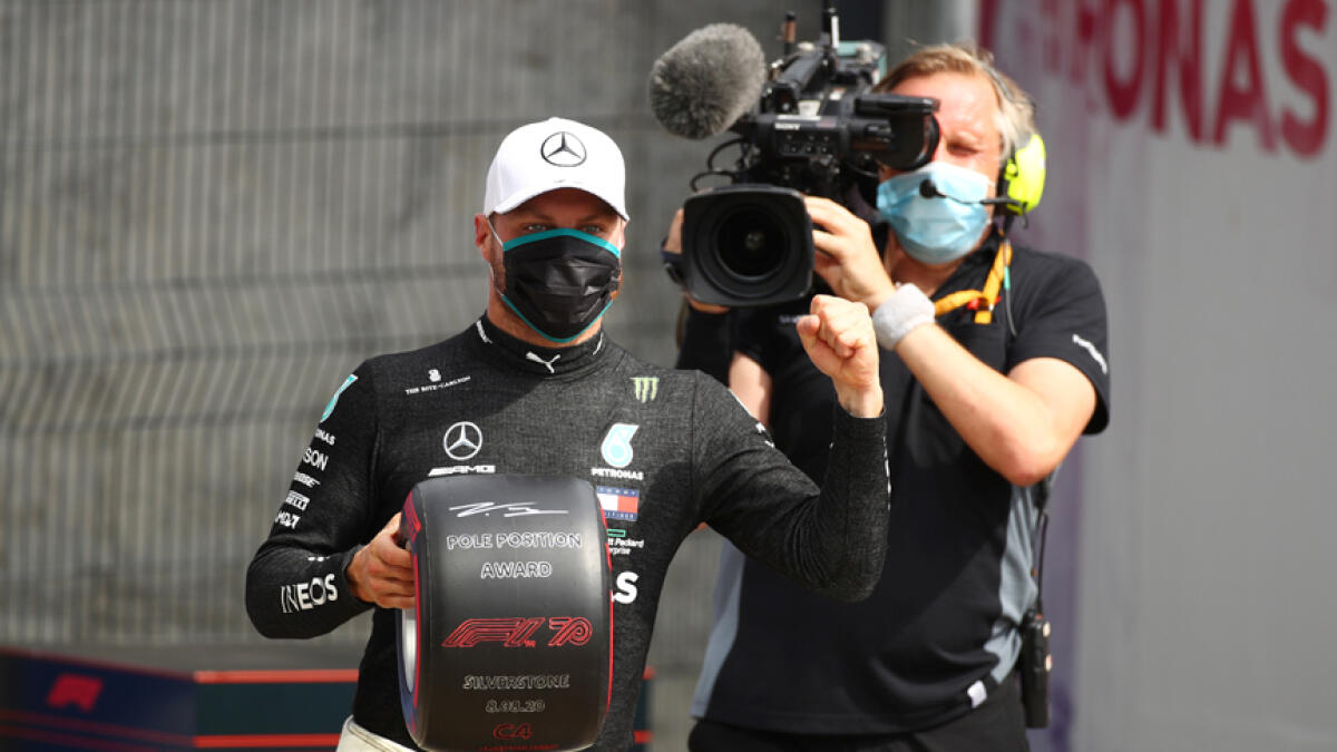 Mercedes' Valtteri Bottas celebrates after qualifying in pole position. - Reuters