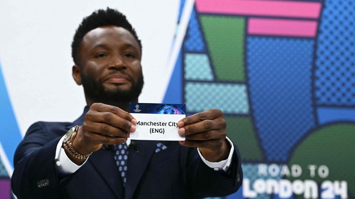Former Nigerian footballer John Obi Mikel holds the paper slip of Manchester City during the Uefa Champions League quarterfinals and semifinals draw in Nyon on Friday. Photo: AFP