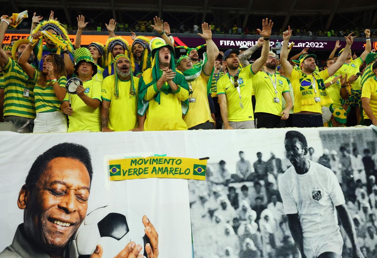 Brazil fans react in the stands as banners with images of former Brazil player Pele are displayed inside the stadium before the match. Reuters