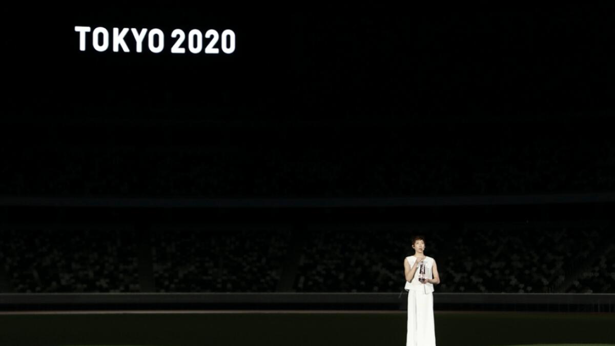 Japanese swimming athlete Rikako Ikee holds the lantern containing the Olympic flame as she speaks during the ‘One Step Forward - +1 Message - TOKYO 2020’ video message unveiling event at the Olympic Stadium in Tokyo, Japan. Photo: Reuters