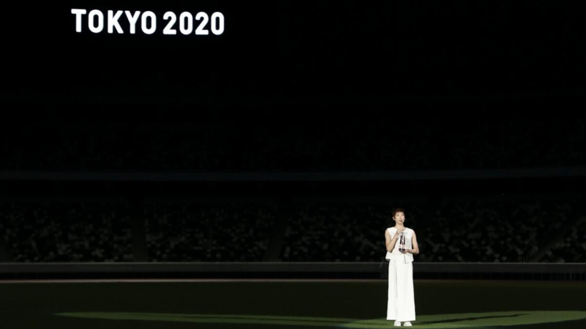 Japanese swimming athlete Rikako Ikee holds the lantern containing the Olympic flame as she speaks during the ‘One Step Forward - +1 Message - TOKYO 2020’ video message unveiling event at the Olympic Stadium in Tokyo, Japan. Photo: Reuters