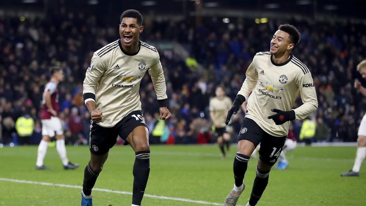 Manchester United’s Marcus Rashford (left) celebrates scoring his second goal of the game with teammate Jesse Lingard against Burnley during their English Premier League match on Saturday night. (AP)