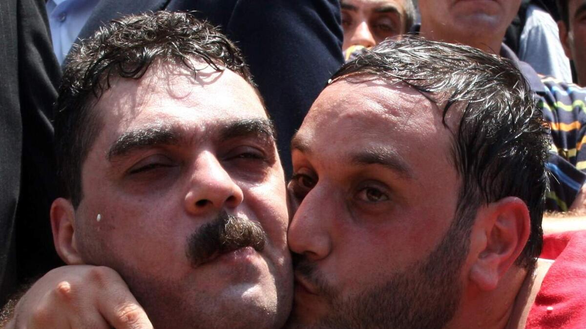 Bassam Qantar (right) kisses his brother Samir Qantar as he arrives in his hometown of Abai, southeast of Beirut, after he was freed by Israel in 2008.