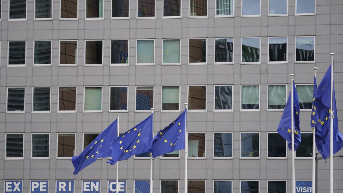 European Union flags flap in the wind in the EU Quarter of Brussels. — AP