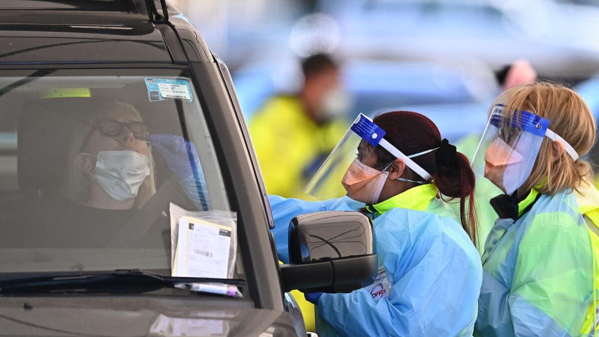 Health workers conduct Covid tests at a drive-through testing clinic at Bondi Beach in Sydney. Photo: AFP