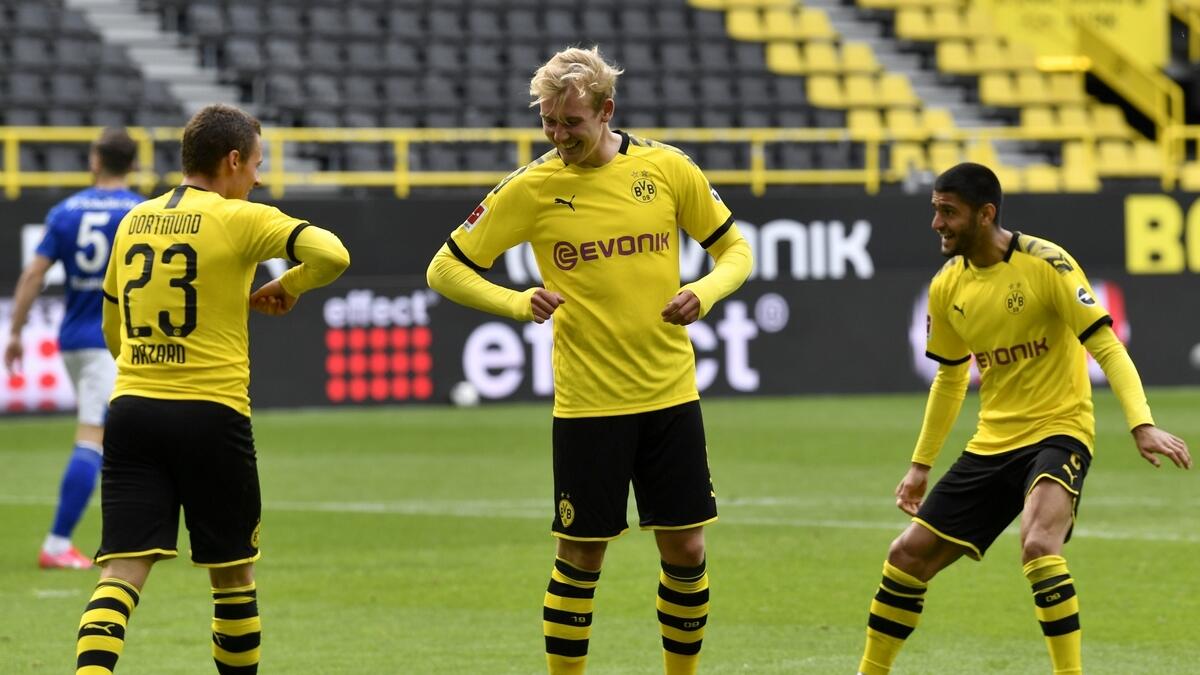 SOCIAL DISTANCING CELEBRATION: Borussia Dortmund players celebrate a goal against Schalke on Saturday. - Agencies