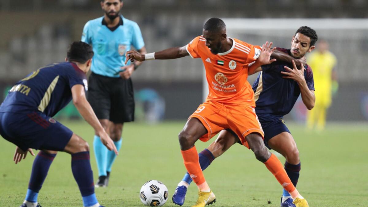 Al Wahda and Ajman players duel for the ball during their Arabian Gulf League match on Saturday. — AGL