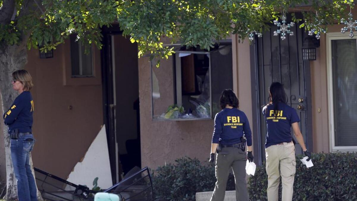 FBI agents search outside the residence that is in connection to the shootings in San Bernardino, California. Officials in Washington familiar with the investigation said there was no hard evidence of a direct connection between the couple and any militant group abroad, but the electronics would be checked to see if the suspects had been browsing on militant websites or social media.