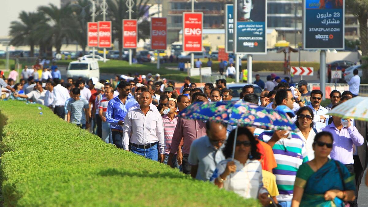 People arriving at the Dubai International Stadium.