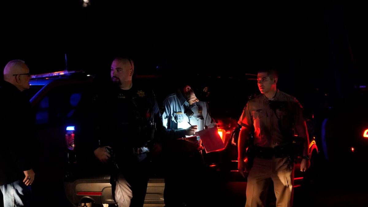 Law enforcement personnel control the scene of a shooting in Half Moon Bay, California. — AP