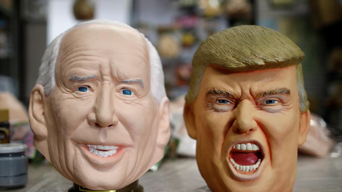 Masks depicting U.S. President-elect Joe Biden and President Donald Trump are displayed at Ogawa Studios, a mask and toy making company, in Saitama, Japan November 12, 2020.
