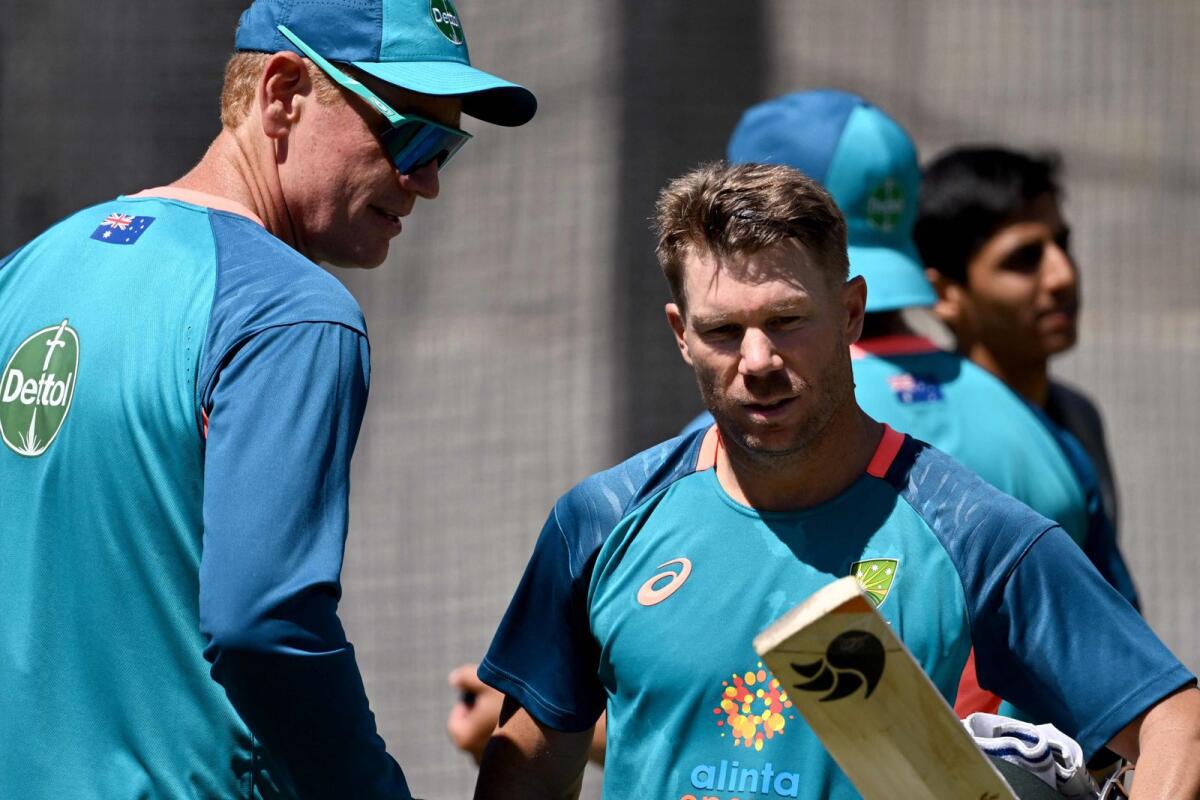 Australia's David Warner (right) speaks with coach Andrew McDonald (left) in the nets at the Melbourne Cricket Ground. (AFP)