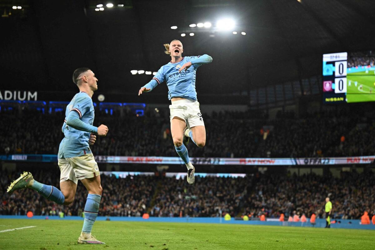 Manchester City's Norwegian striker Erling Haaland (right) celebrates after scoring the opening goal against Burnley. — AFP