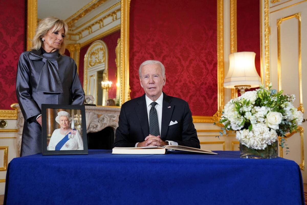 U.S. President Joe Biden and first lady Jill Biden prepare to sign a condolence book for Britain's Queen Elizabeth. Photo: Reuters