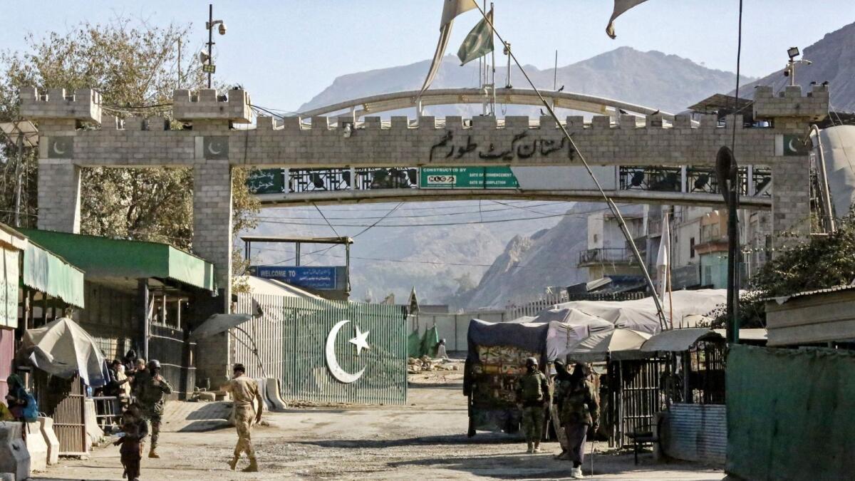 Border security personnel of Afghanistan and Pakistan stand guard at the zero point Torkham border crossing between the two countries, in Nangarhar province. — AFP