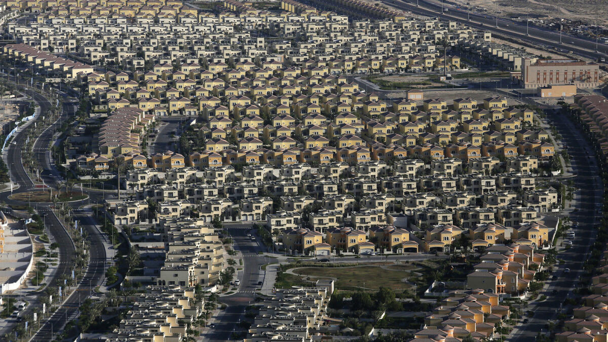 Newly-built residential villas sit in a district on the outskirts of Dubai, United Arab Emirates, on Tuesday, Nov. 11, 2014. Declining currencies in European countries whose citizens are among the leading buyers of Dubai homes are combining with falling oil prices and a tax on foreign property held by Indians to push down home prices in the emirate. Photographer: Chris Ratcliffe/Bloomberg