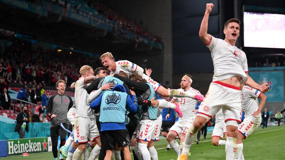Denmark's players celebrate after their third goal against Russia. (AFP)