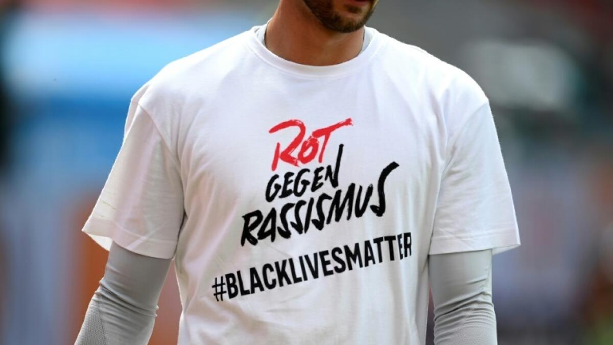 Bayern players wore t-shirts bearing the Black Lives Matter hashtag and the slogan of the club's official 'Reds Against Racism' campaign. - AFP