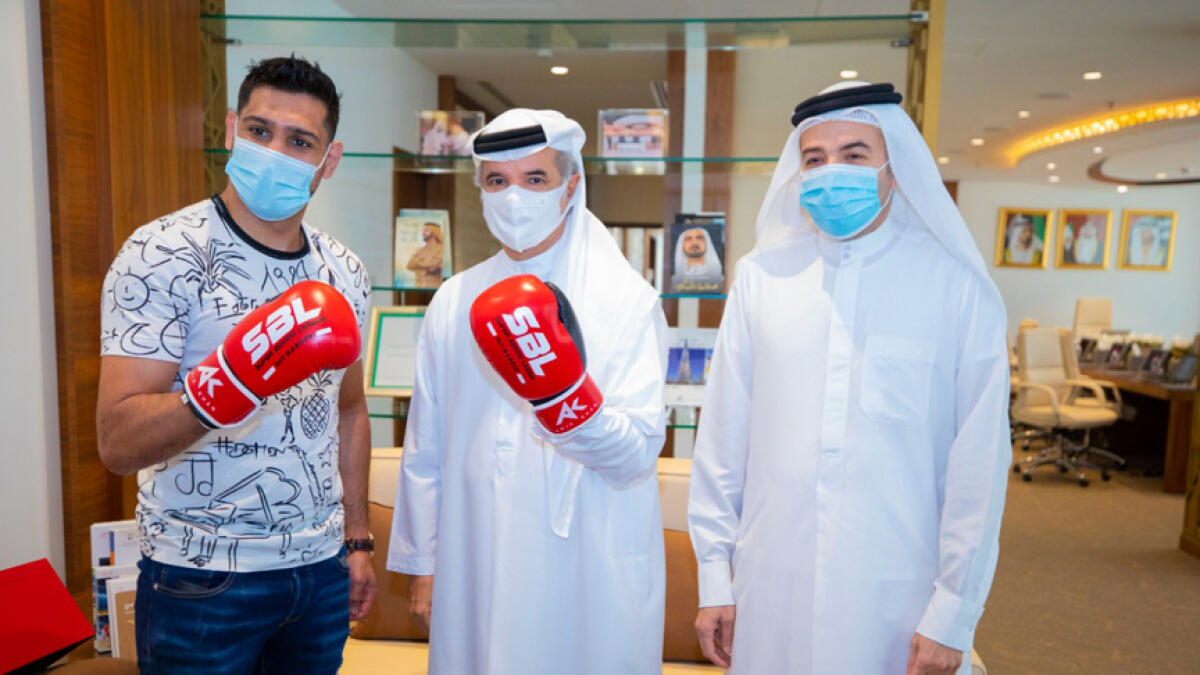 Amir Khan (left) seen with Saeed Hareb, secretary general of Dubai Sports Council and Nasser Aman Al Rahma, assistant secretary general of Dubai Sports Council, to discuss his future projects. - Supplied photo