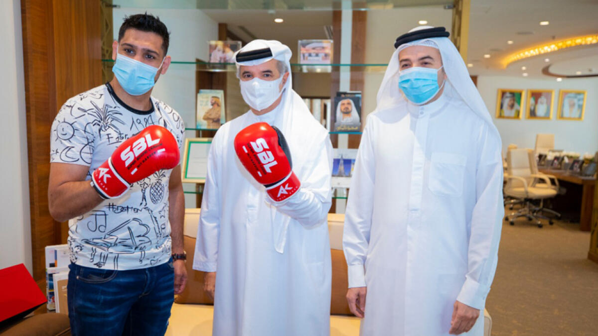 Amir Khan (left) seen with Saeed Hareb, secretary general of Dubai Sports Council and Nasser Aman Al Rahma, assistant secretary general of Dubai Sports Council, to discuss his future projects. - Supplied photo