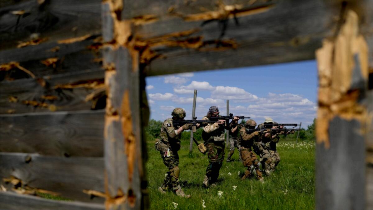 Civilian militia men hold shotguns during training at a shooting range in outskirts Kyiv. — AP