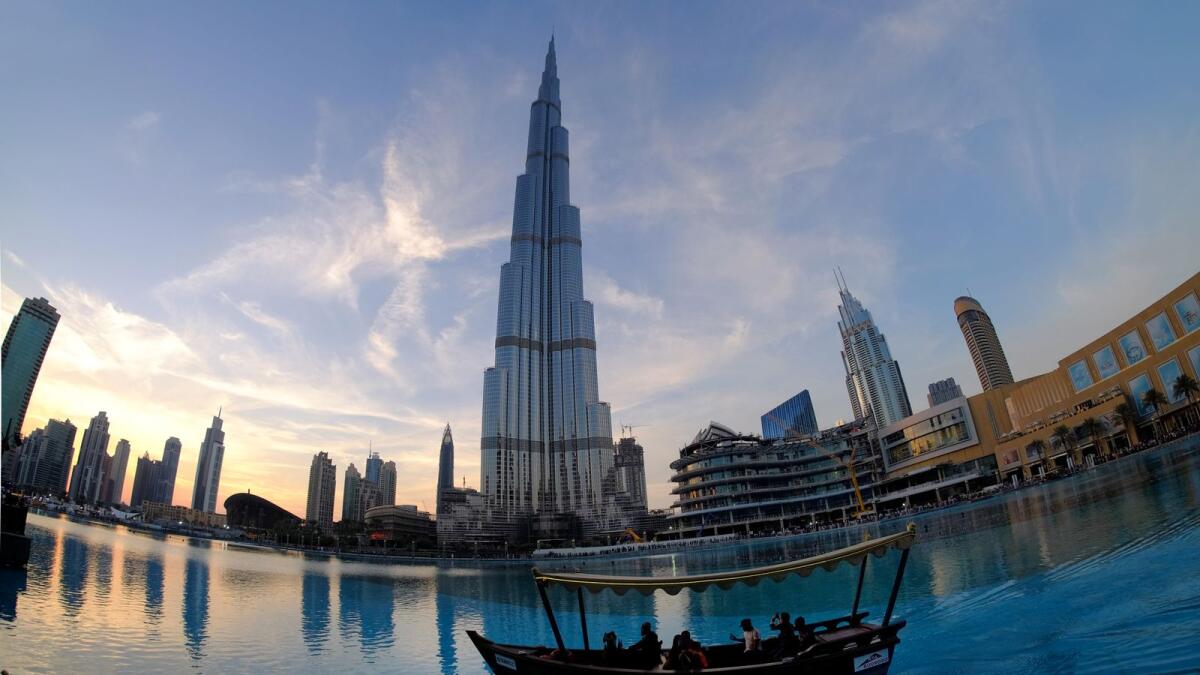 Tourists take a ride in Abra in front of Burj Khalifa downtown. — File photo