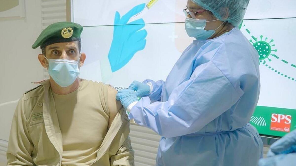 Lt General Abdullah Khalifa Al Marri receives the first dose of Covid-19 vaccine.