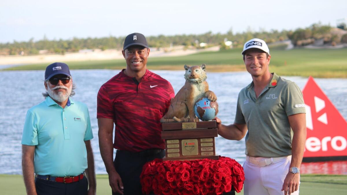 Victor Hovland (right) with the trophy along with Tiger Woods (centre). Supplied photo