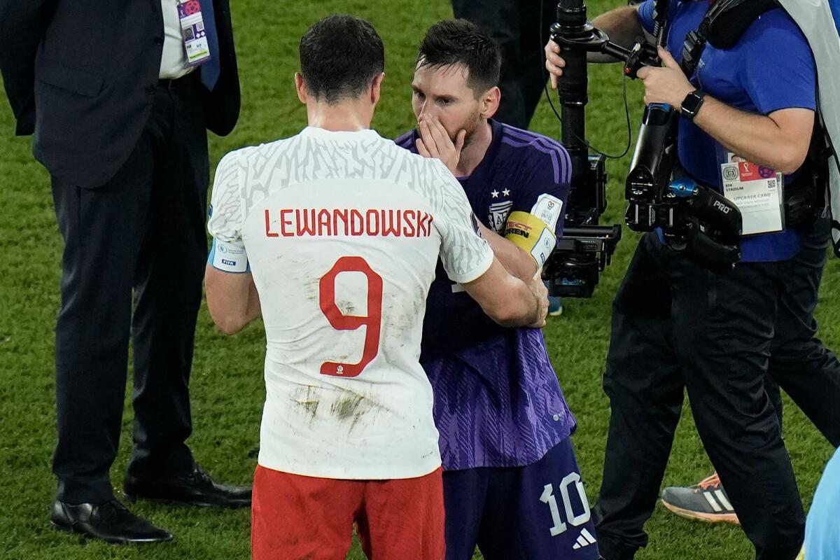 Poland's Robert Lewandowski speaks to Argentina's Lionel Messi at the end of the World Cup Group C match in Doha on November 30, 2022. — AP